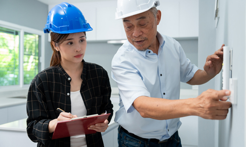 senior-home-inspector-checking-electrical-switch